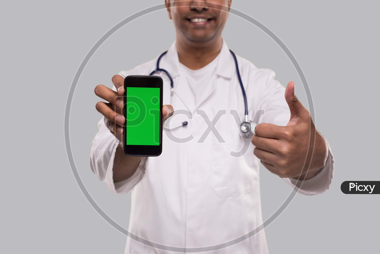 Doctor Holding Phone Showing Thumb Up Close Up Isolated. Indian Man Doctor Technology Medicine At Home. Phone Green Screen.