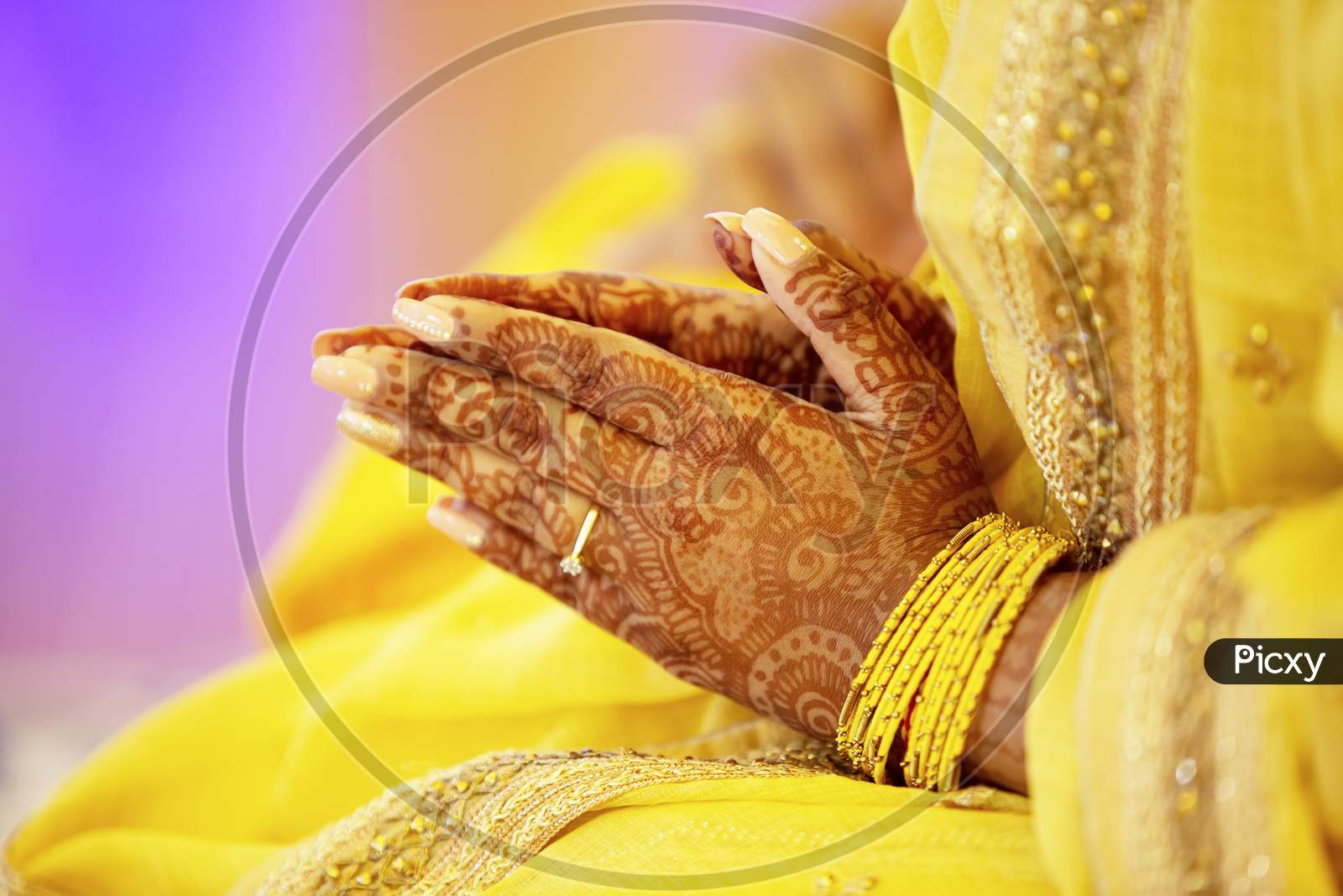 Hindu bride hand with mehendi  on the day of haldi ceremony.
