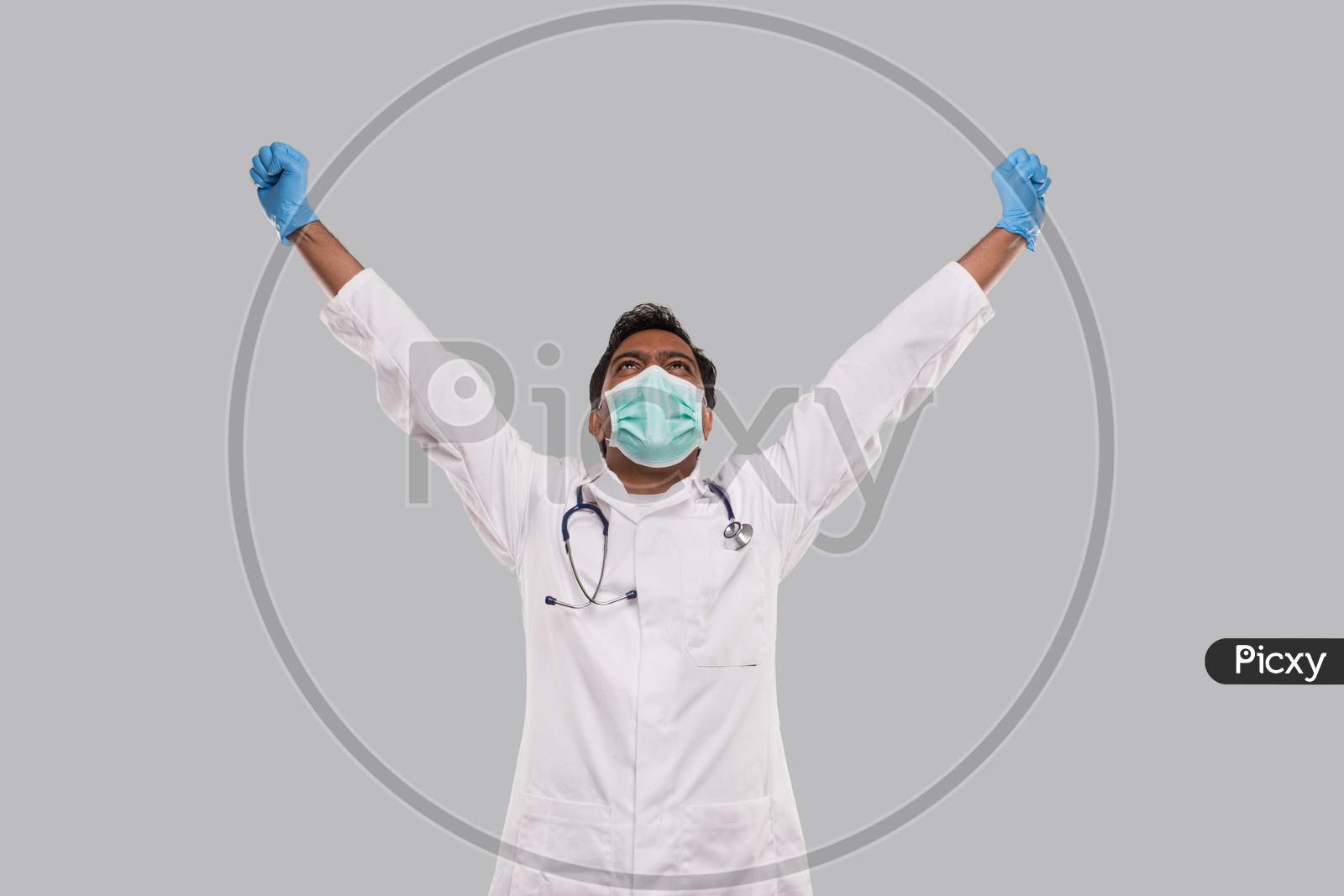 Doctor Excited Hands Up Celebrating Success Wearing Medical Mask And Gloves Isolated. Indian Man Doctor Happy