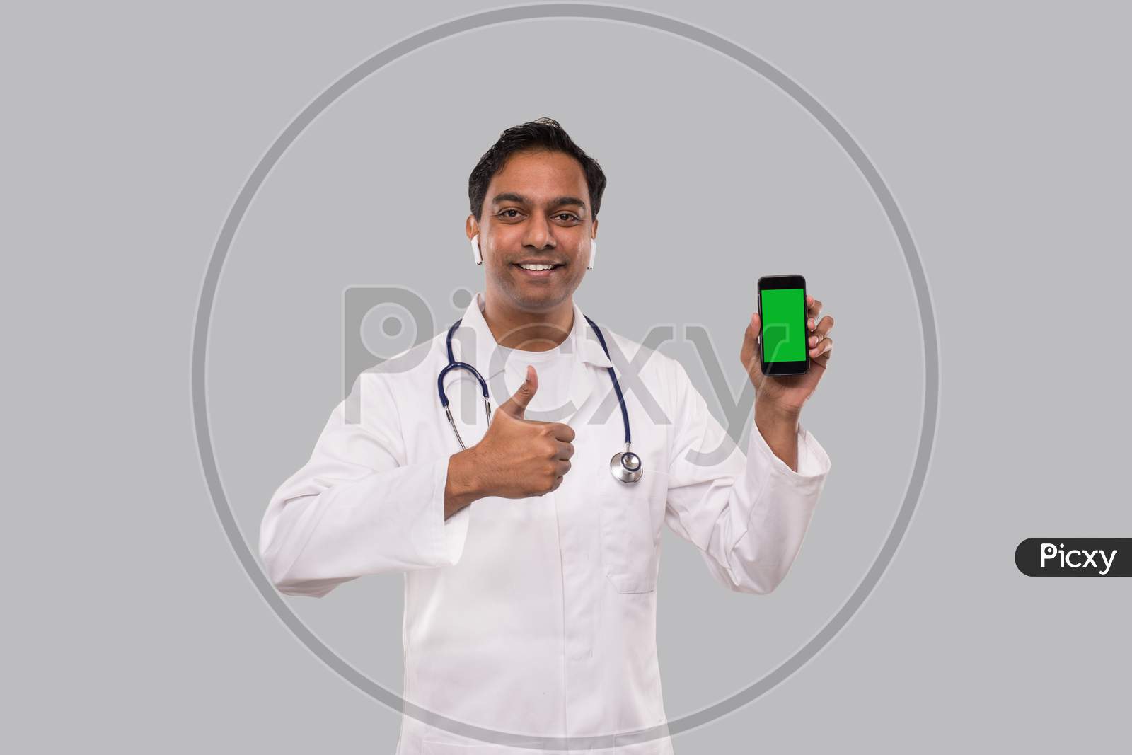 Doctor Holding Phone Showing Thumb Up Isolated. Indian Man Doctor Technology Medicine At Home. Phone Green Screen.