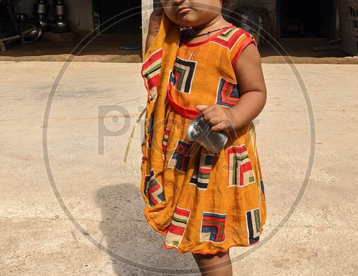 Baby girl in rural area. Small baby girl from village.