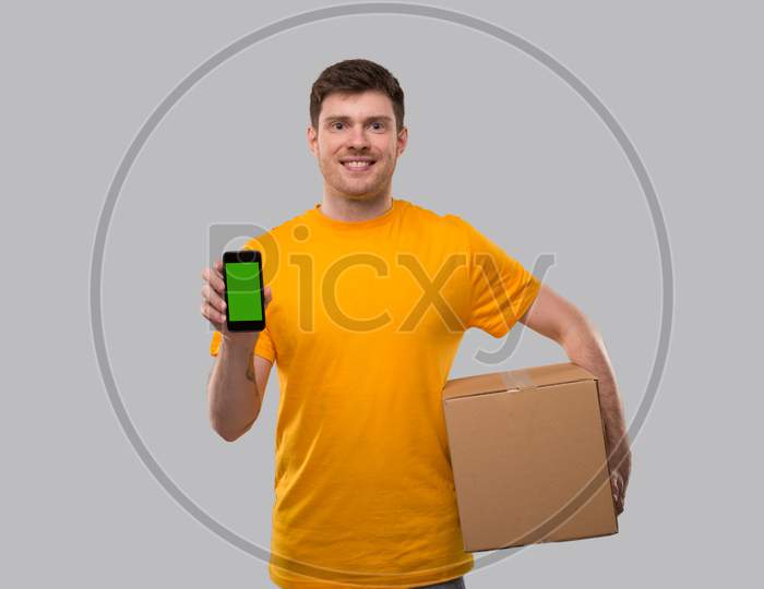 Delivery Man Showing Phone Holding Box. Phone Green Screen. Delivery Boy Smiling. Man With Parcel In Hands