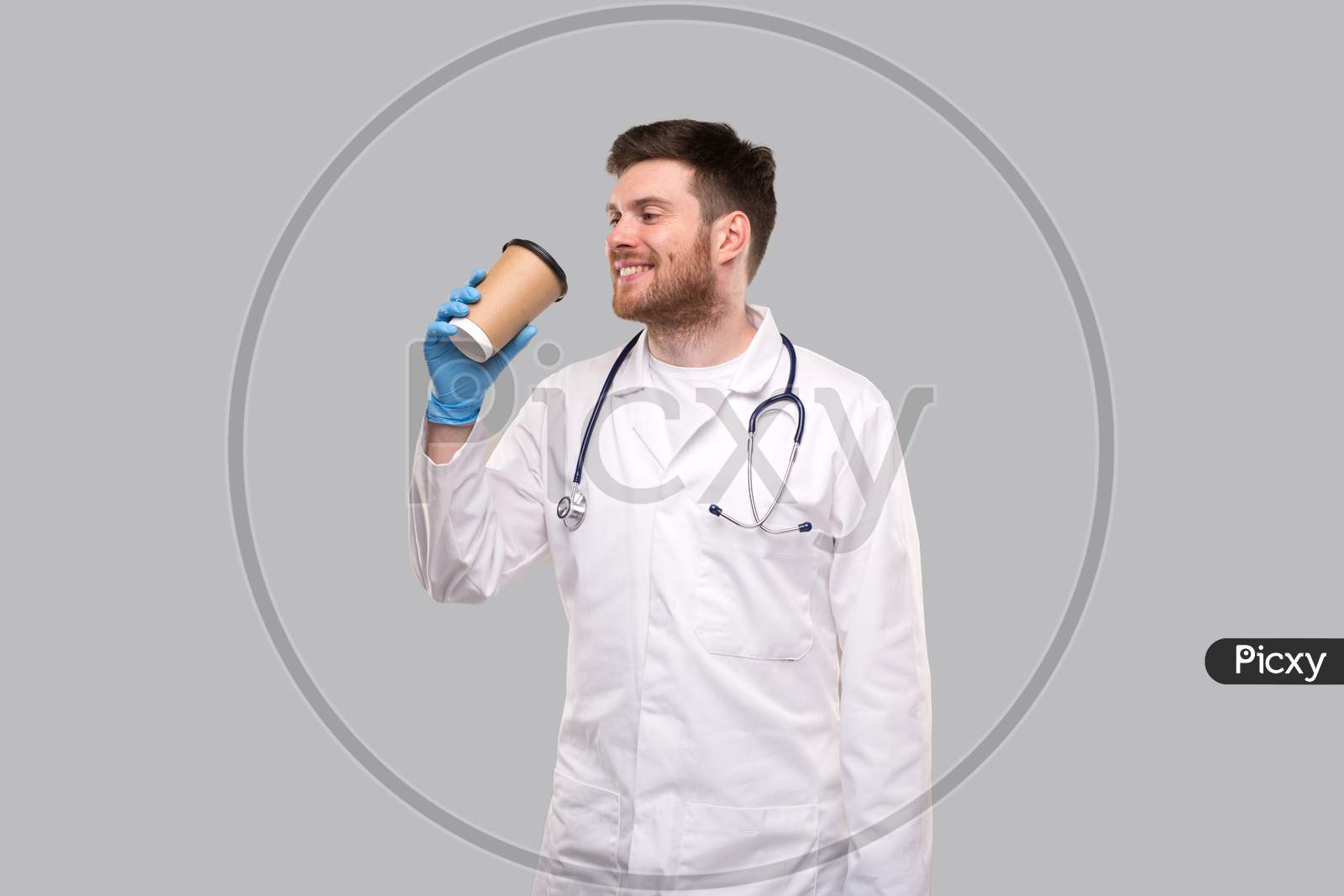 Doctor Drinking Coffee From To Go Cup Smiling Isolated