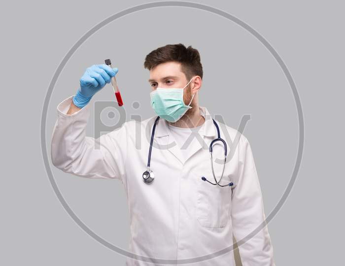 Male Doctor Checking Blood Analysis Wearing Medical Mask And Gloves. Doctor Isolated