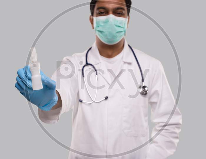 Doctor Showing Nose Spray Wearing Medical Mask And Gloves Close Up. Indian Man Doctor Nasal Spray. Corona Virus Concept. Isolated