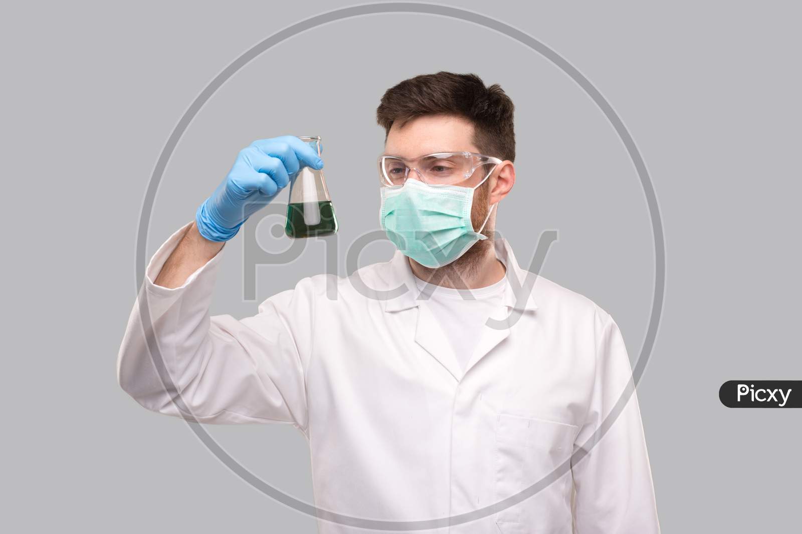 Male Doctor Wearing Medical Mask And Glasses Watching Flask With Colorfull Liquid. Science, Medical, Virus Concept