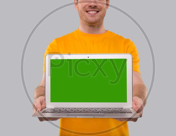 Man Showing Laptop Green Screen. Home Orders, Quarantine Delivery, Shopping Online, Freelance Worker Concept. Close Up