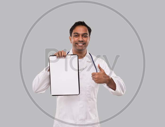 Doctor Holding Clipboard Showing Thumb Up Isolated. Indian Man Doctor Blank Clipboard In Hands