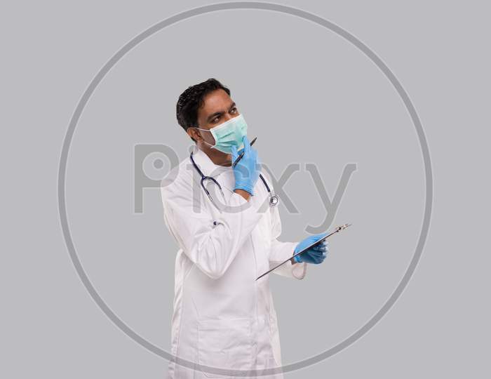 Doctor Thinking With Clipboard Wearing Medical Mask And Gloves. Indian Man Doctor Clipboard Isolated