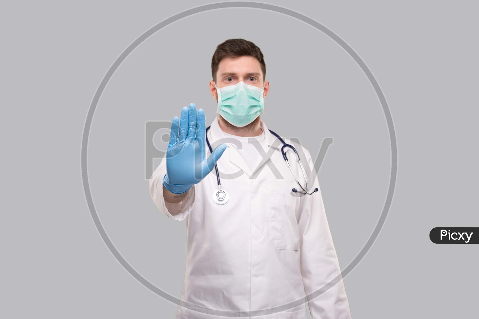 Male Doctor Showing Stop Sign. Doctor Wearing Medical Mask And Gloves. Focus On Hand. Stop Virus Concept