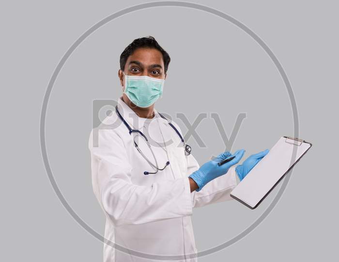 Doctor Writing In Clipboard Watching In Camera. Indian Man Doctor Clipboard Isolated