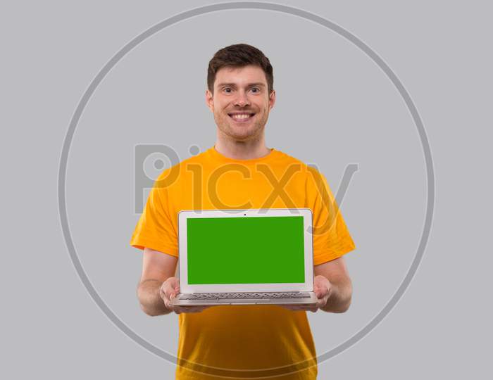 Man Showing Laptop Green Screen. Home Orders, Quarantine Delivery, Shopping Online, Freelance Worker Concept.