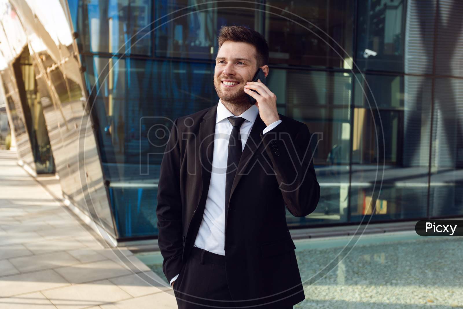 Businessman Talking On Phone Isolated. Business Man Standing Full Length With Phone In Hand