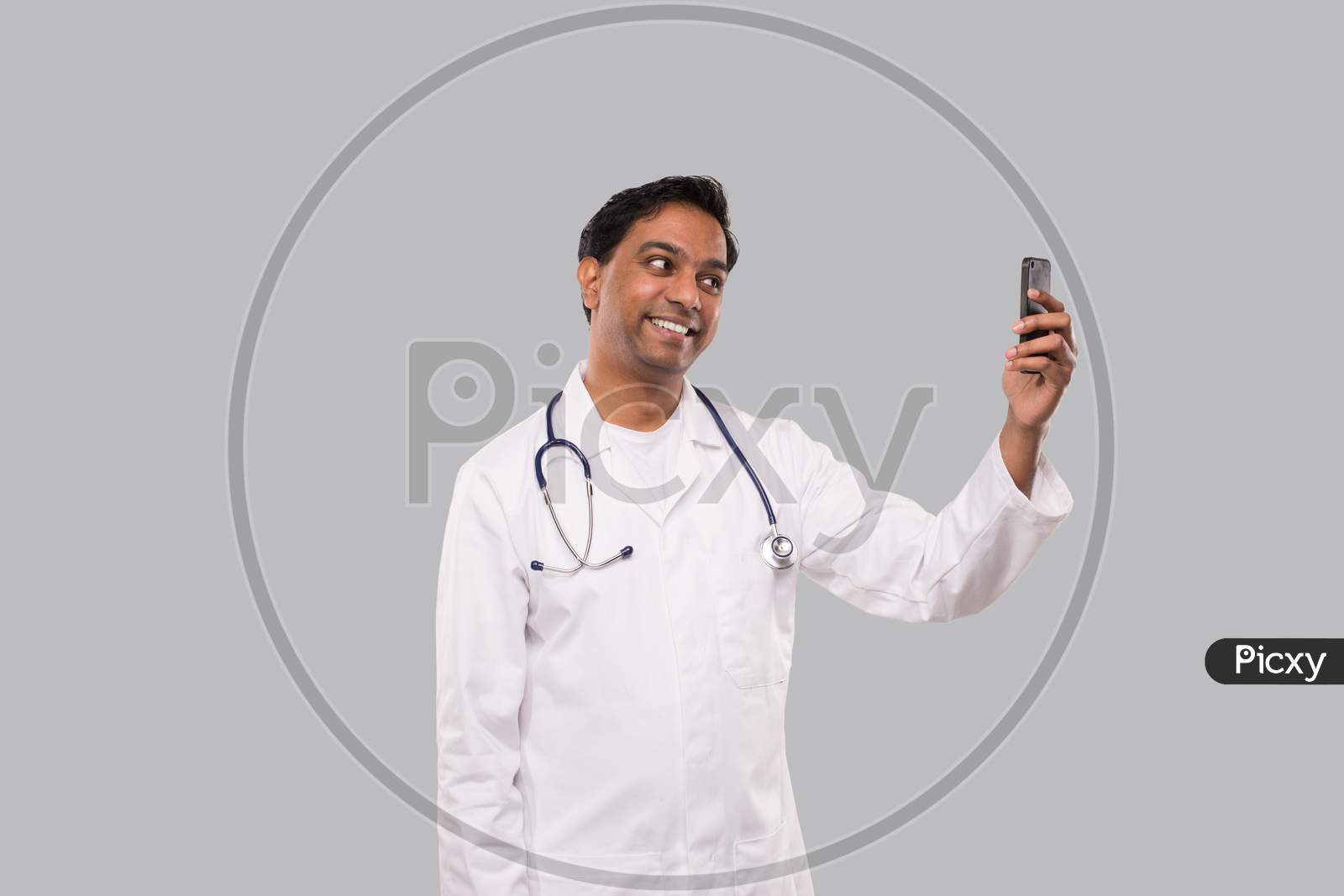 Doctor Having Video Call On Phone Isolated. Indian Man Doctor Video Call. Medicine Online. Doctor Using Phone.