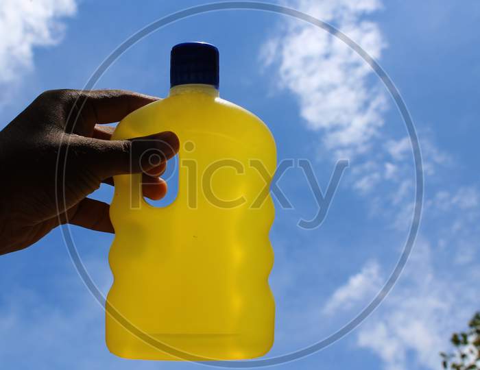 Hand sanitizer in the hand with blur sky background