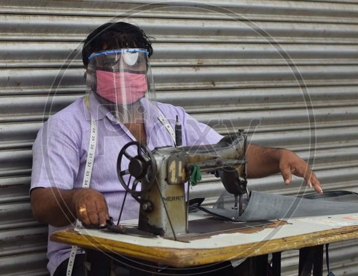 Hyderabad, Telangana, India. July-19-2020: Tailor Is To Repair, Make, And Adjust Clothes While His Wearing Protective Face Mask. Man With Safety Mask On His Face, Pandemic Concept