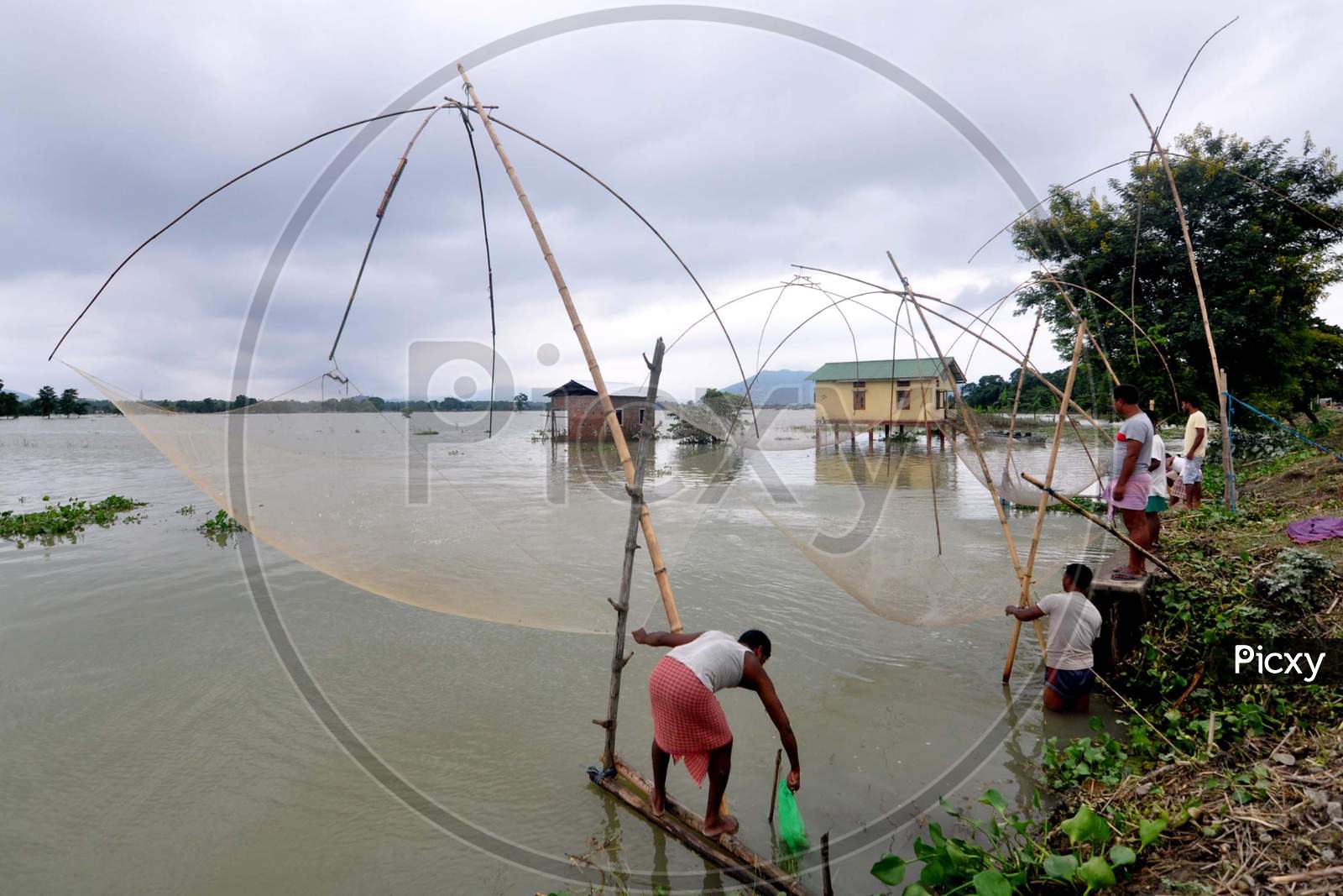 Villagers fish in flooded waters in Morigaon, Assam on July 18, 2020