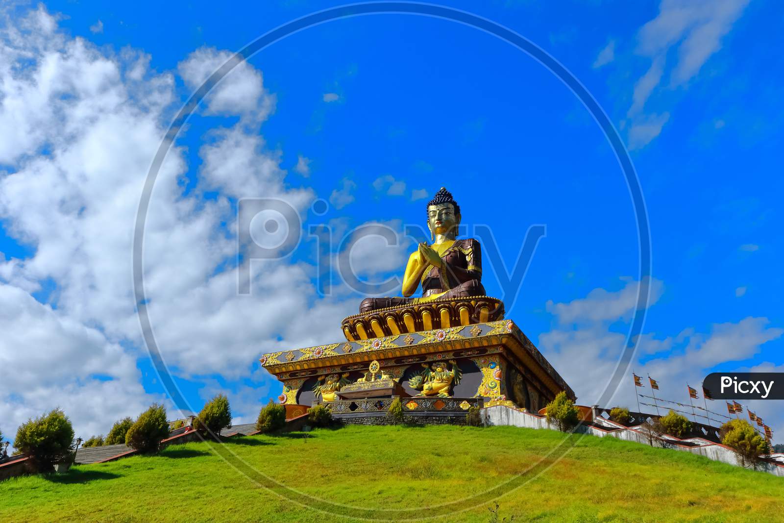 The statue of Buddha  with blue sky and clouds