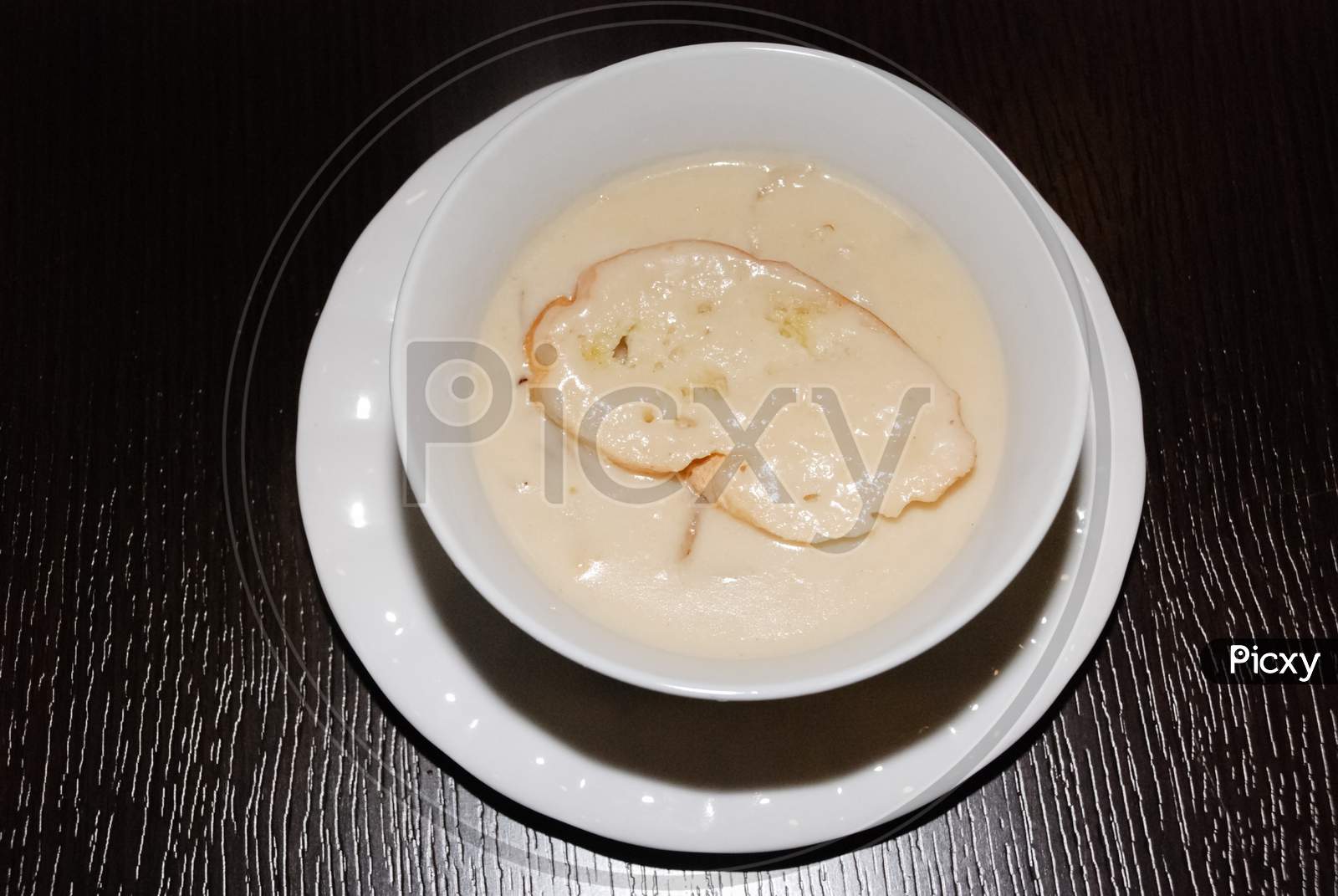 Shiny Creamy Mushroom Soup In The White Bowl