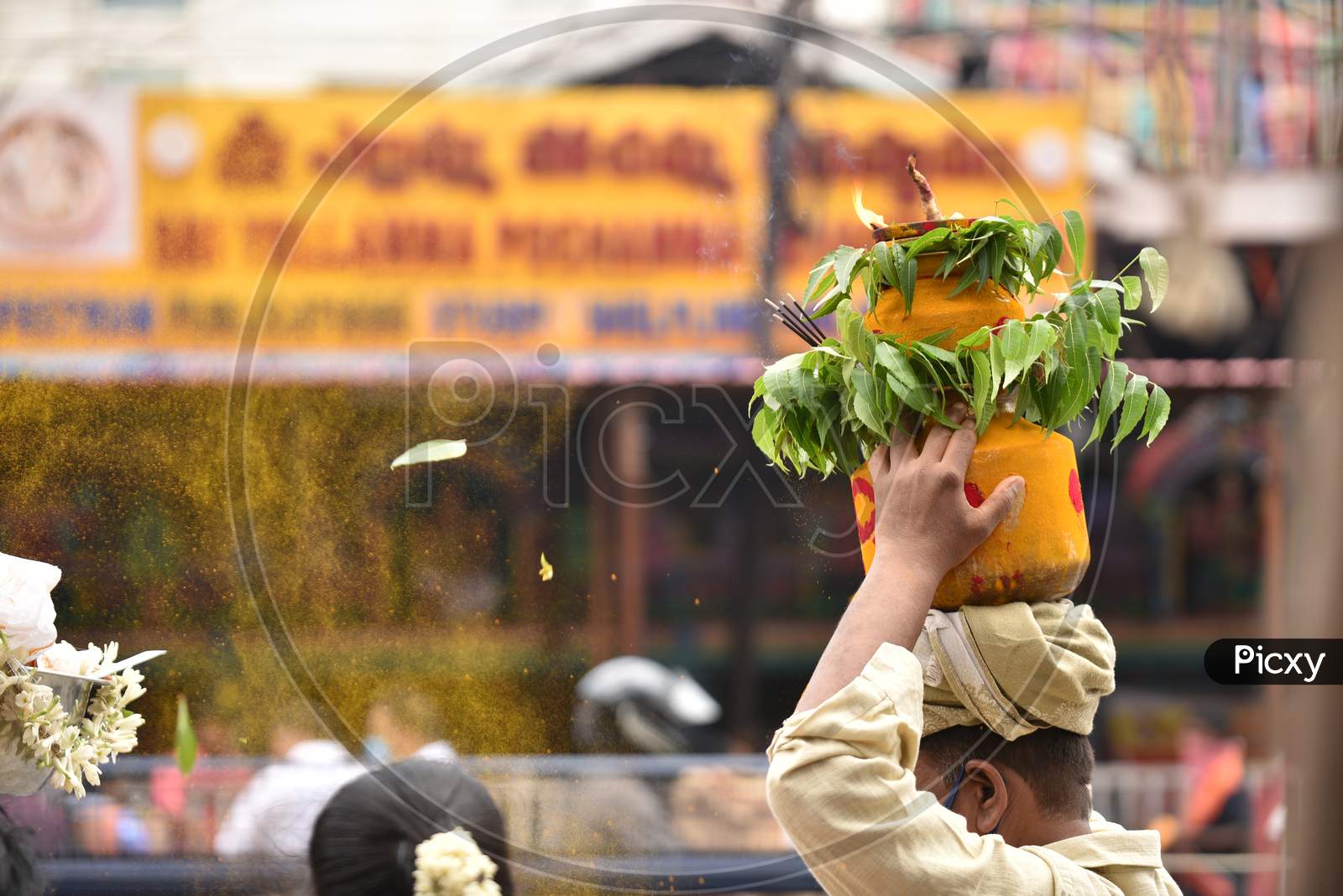 A man carries a 'Bonam' outside Yellamma Pochamma temple, July 19, 2020,Balkampet,Hyderabad.