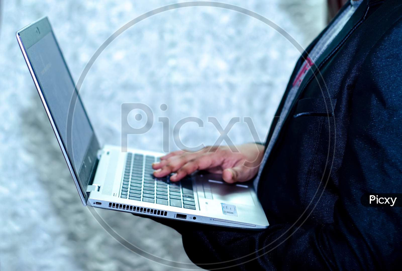 business man holding a laptop