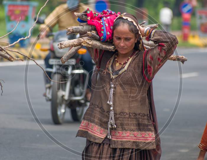 A women carrying burden for her family