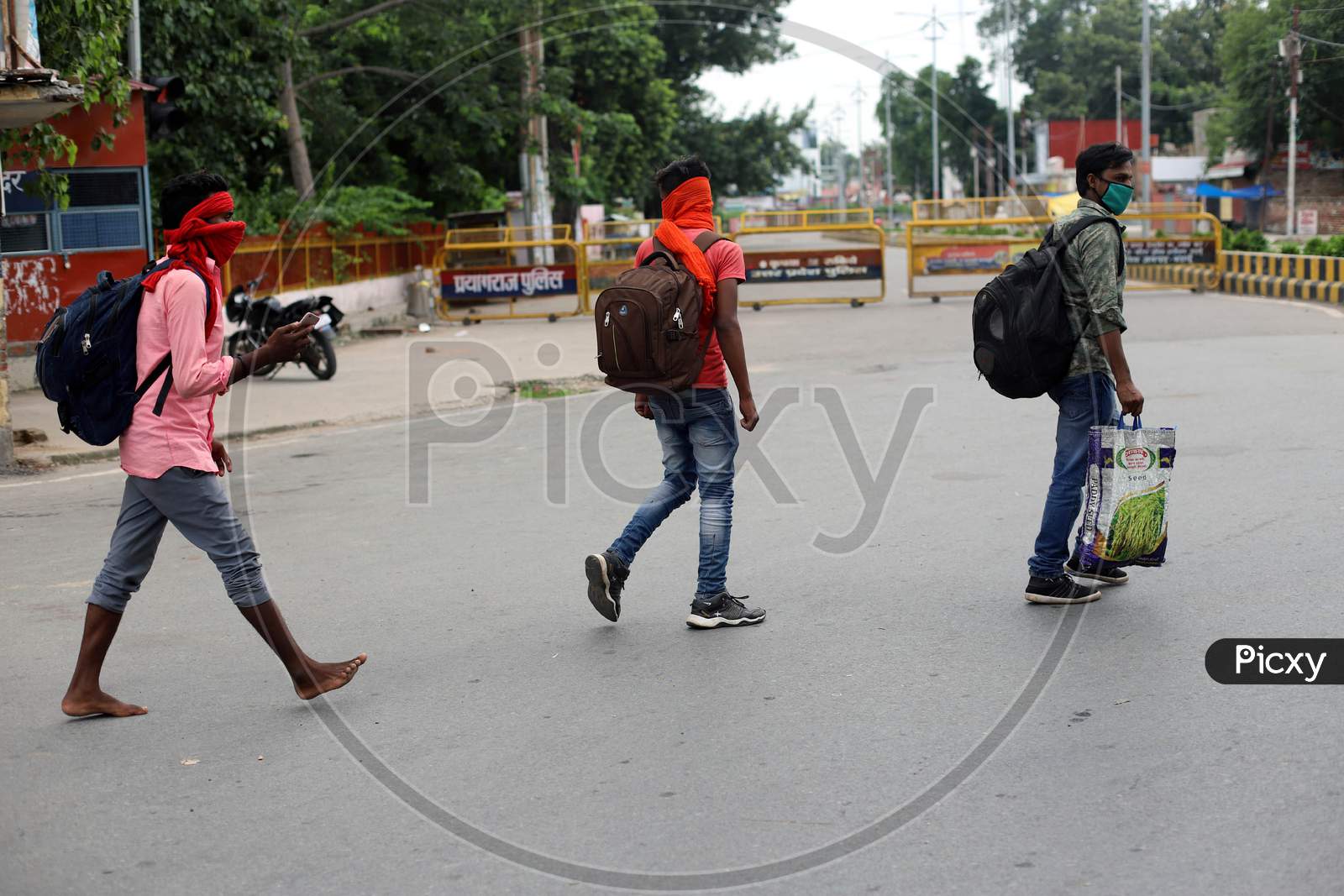People Walk On The Empty Road during Total Lockdown Imposed By Uttar Pradesh Government Due To Surge In Covid-19 Cases In Prayagraj, July 19, 2020.