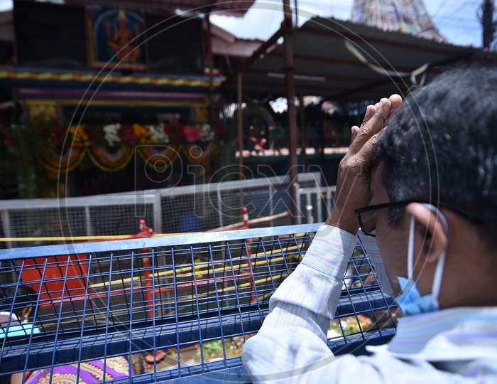 a man prays outside a closed Yellamma Pochamma Temple amid raising fears of coronavirus, July 19, 2020, Balkampet, Hyderabad, Bonalu 2020.