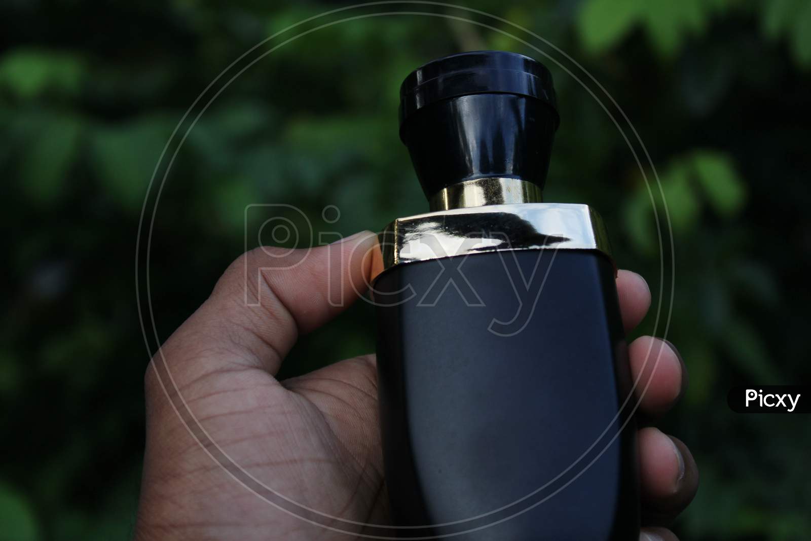 Perfume bottle catch the hand with natural background