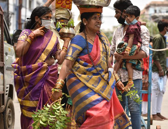 A woman dances with a 'Bonam' offering on her head outside a closed Yellamma Pochamma temple in Balkampet, Bonalu 2020, Hyderabad, July 19.