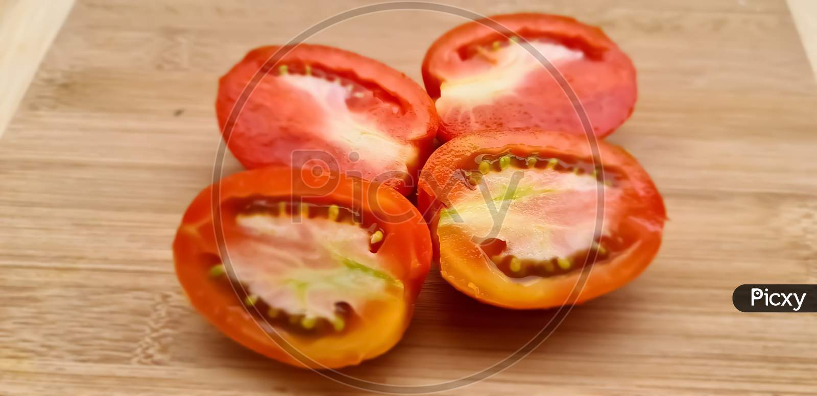 Tomatoes slices with wooden background