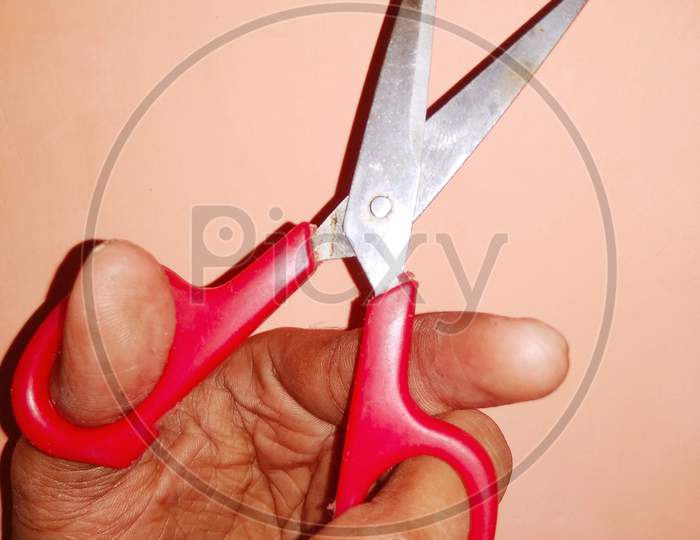 A man hand with the scissors