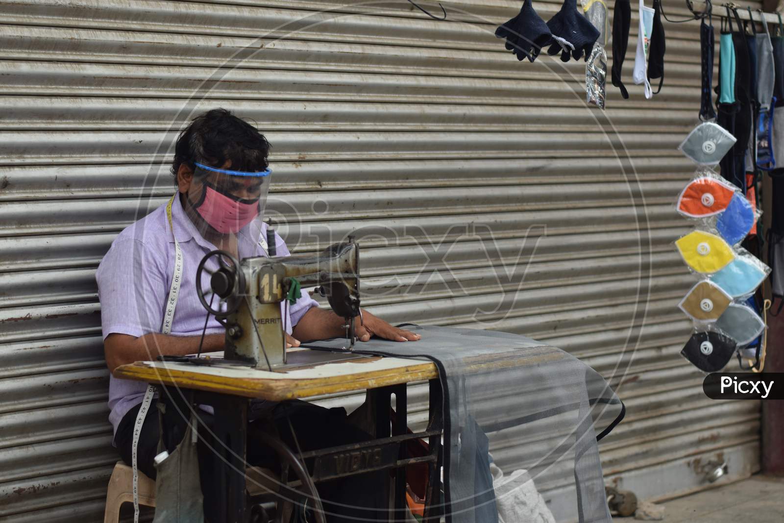 Hyderabad, Telangana, India. July-19-2020: Tailor Is To Repair, Make, And Adjust Clothes While His Wearing Protective Face Mask. Man With Safety Mask On His Face, Pandemic Concept