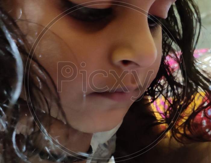 A cute curly hair Asian Indian baby playing in home