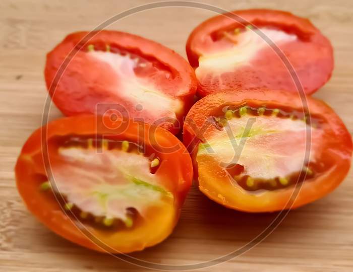 Tomatoes slices with wooden background