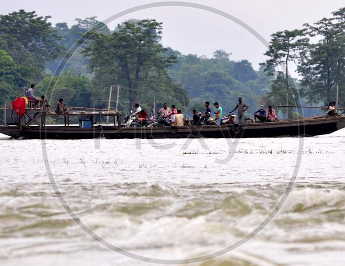 Villagers cross a flooded area on a boat at Mayong village in Morigaon, Assam on July 18, 2020
