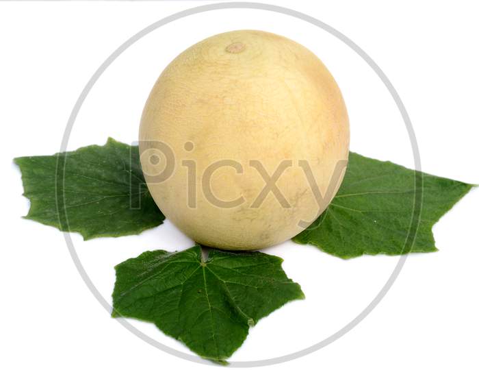 the yellow muskmelon with green leaves isolated on white background.