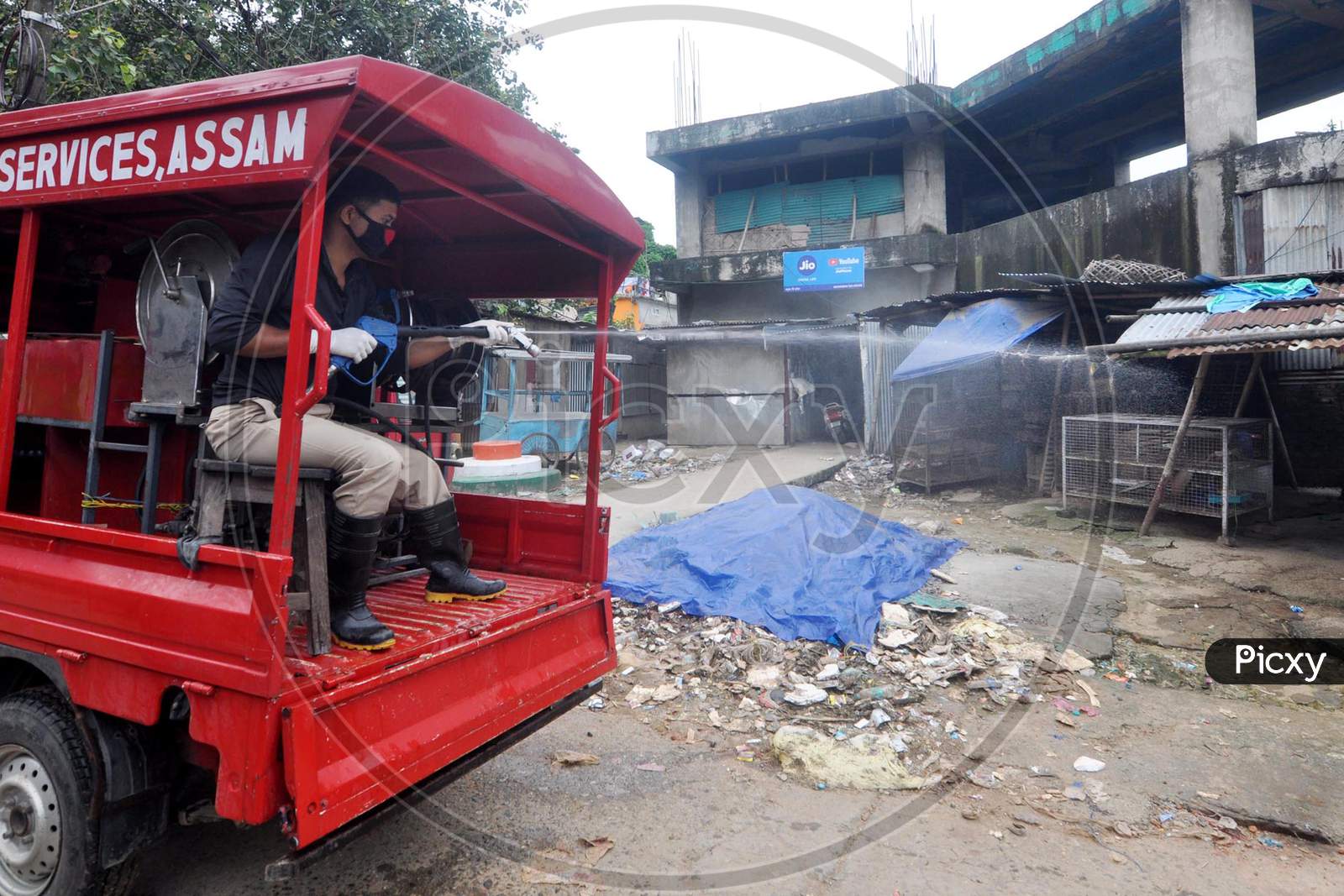 A firefighter sprays disinfectant in a market area during a lockdown in Guwahati, Assam on July 02, 2020.