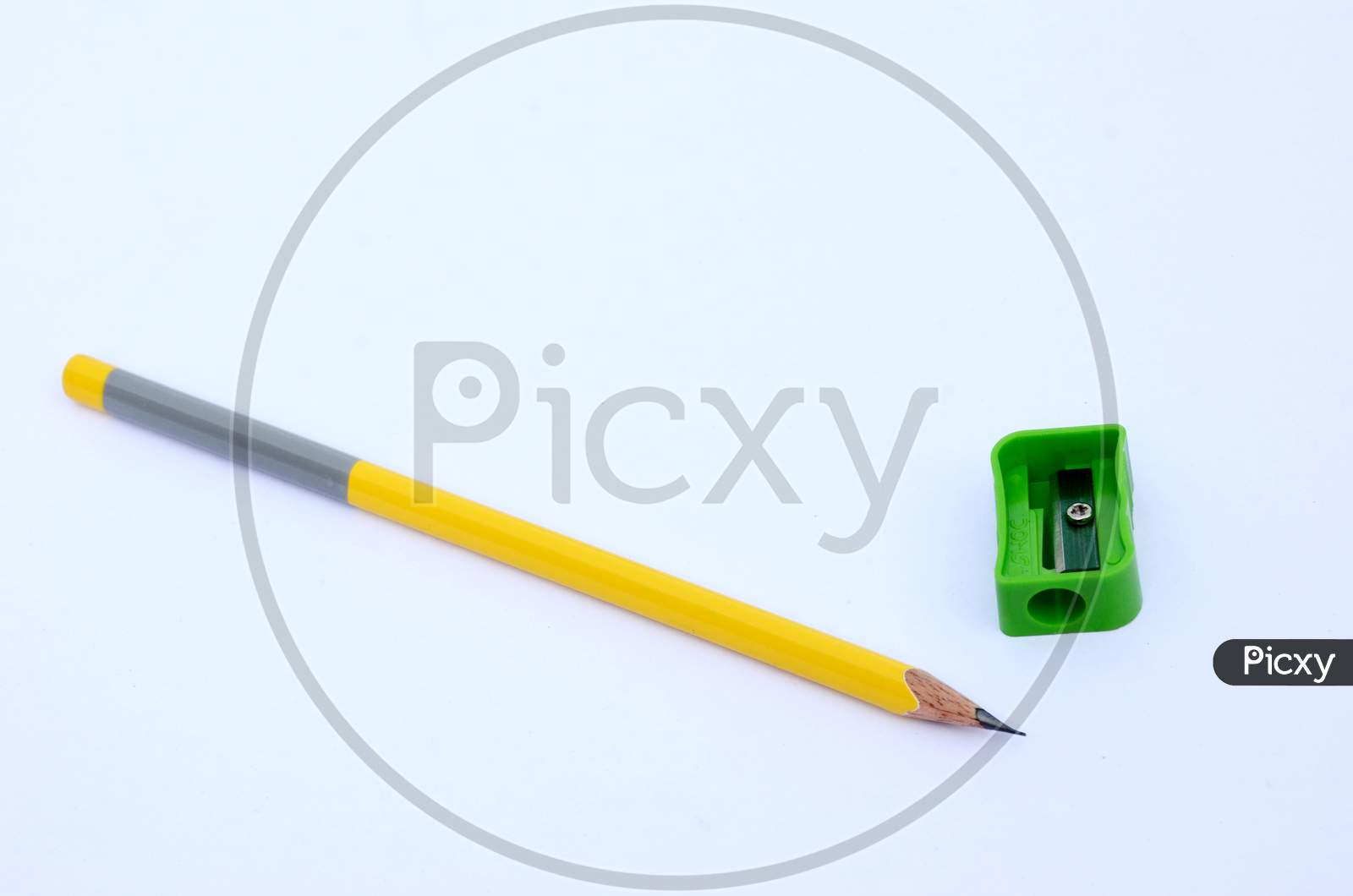 the yellow wooden pencil with green sharpner isolated on white background.