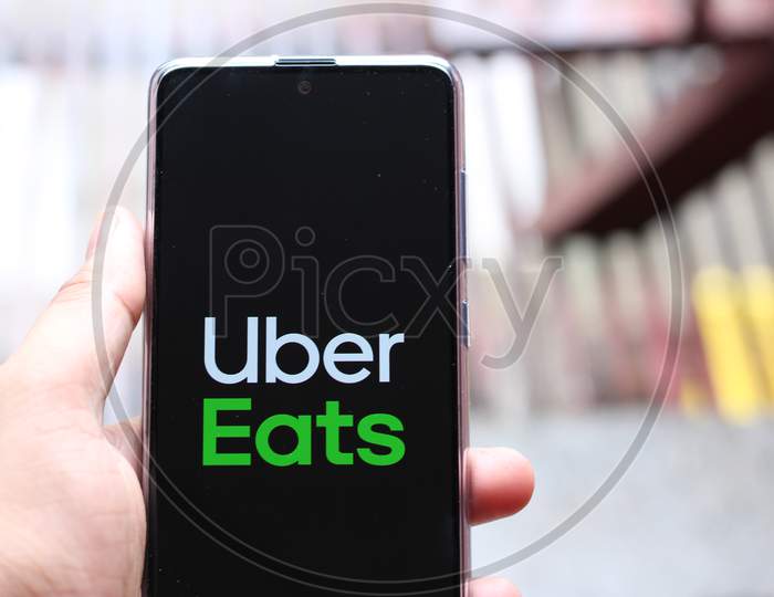 Uber eats application on smartphone with blurry background.