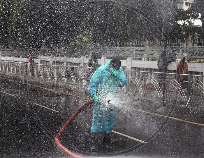 Firefighter spraying disinfectant on the roads to prevent the spread of Coronavirus in a containment zone in Chennai.