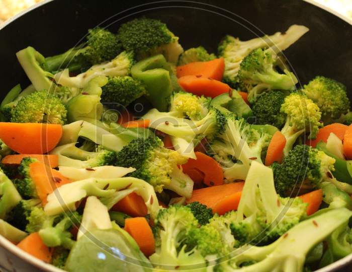 Cooking Half cooked vegetables on black fry pan