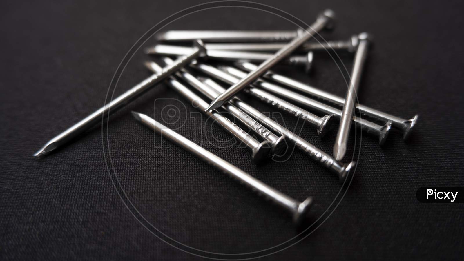 Closeup Shot Of Some Steel Nails On A Black Surface