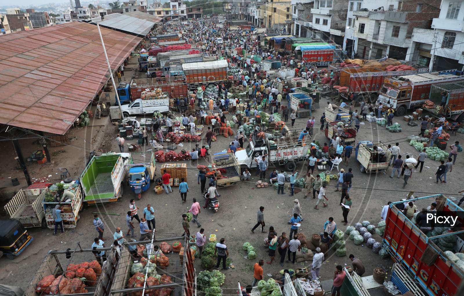A view of people at a wholesale vegetable market seen defying social distancing guidelines, during Unlock 2.0, in Jammu
