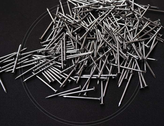 Panoramic Shot Of A Pile Of Steel Nails On A Black Background