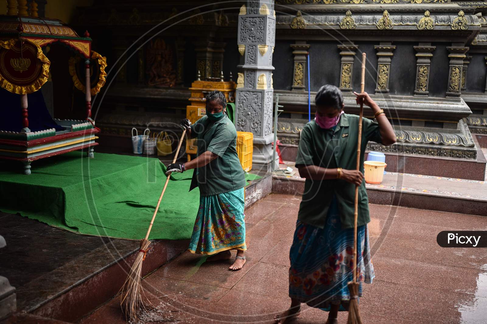 Sanitary workers clean the premises of the Kanaka Durga temple ahead of the Shakhambari Devi in Vijayawada.