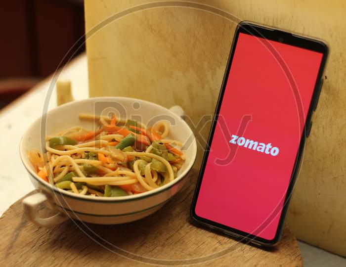 Zomato Food delivery application icon on smartphone.