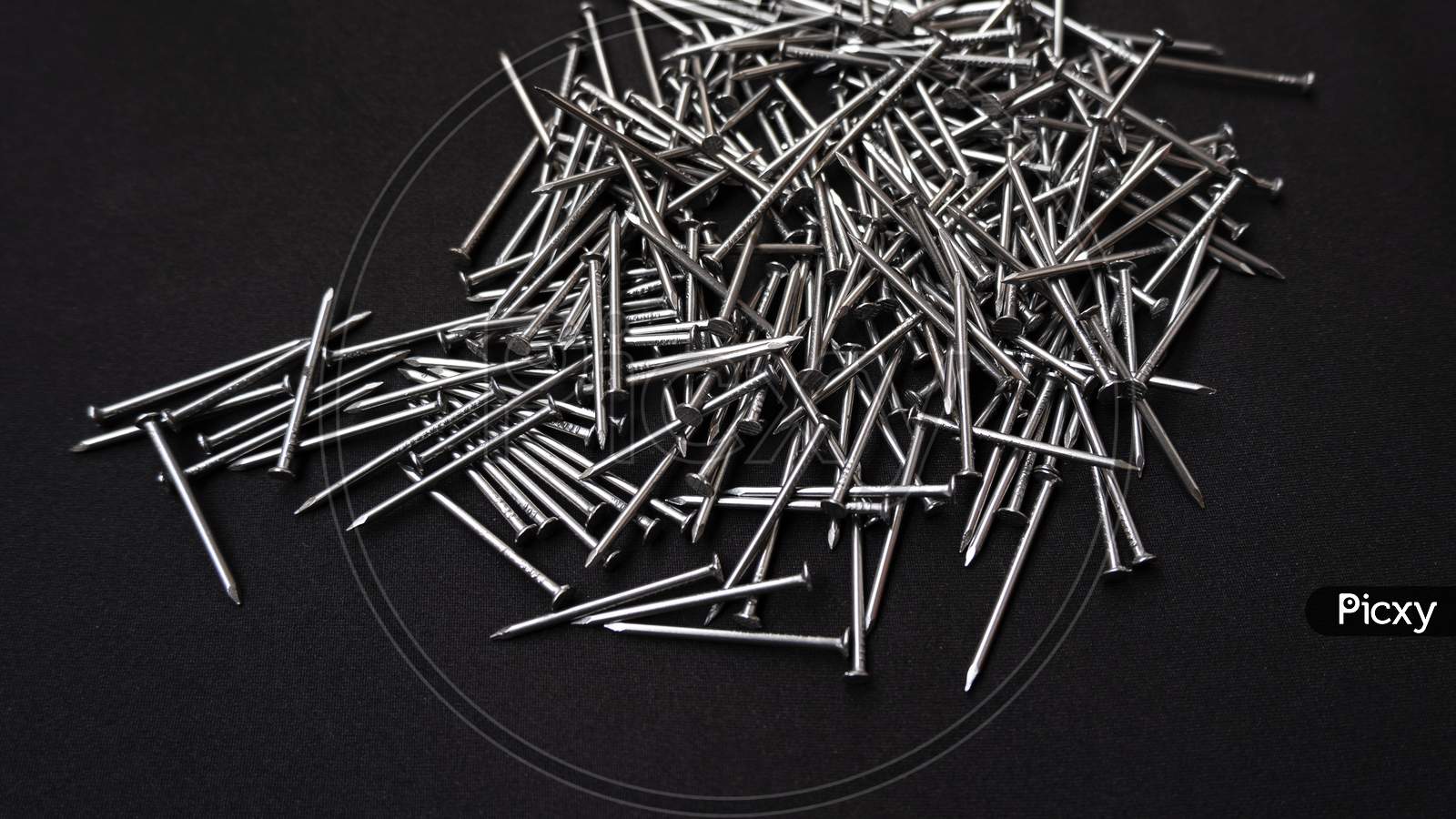 Panoramic Shot Of A Pile Of Steel Nails On A Black Background