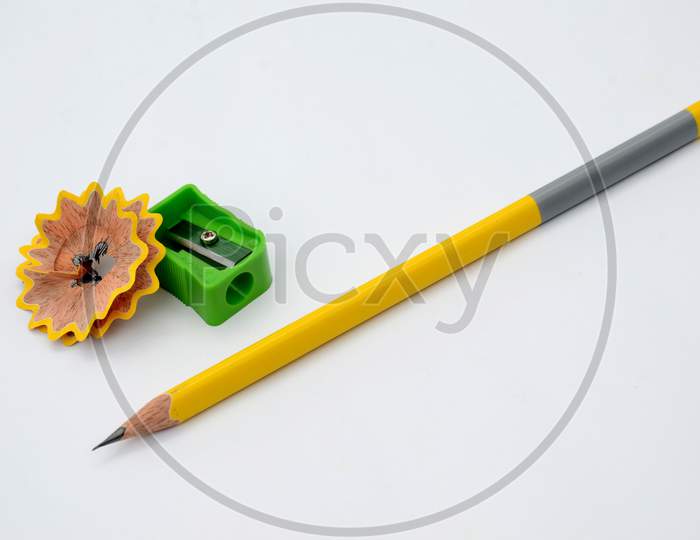 the yellow  wooden pencil with green sharpner isolated on white background.
