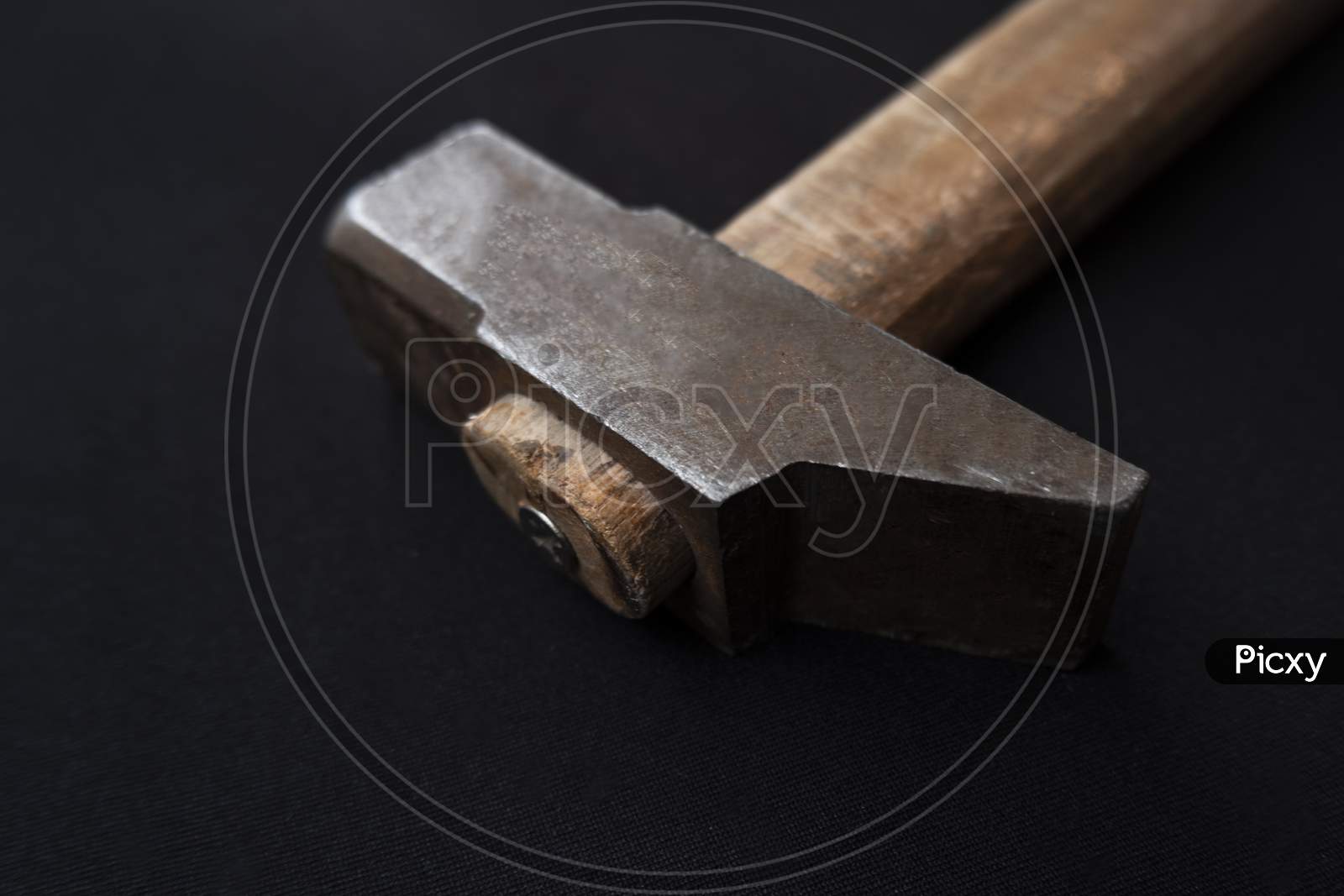 Closeup Shot Of A Hammer With A Wooden Handle Isolated On A Black Background